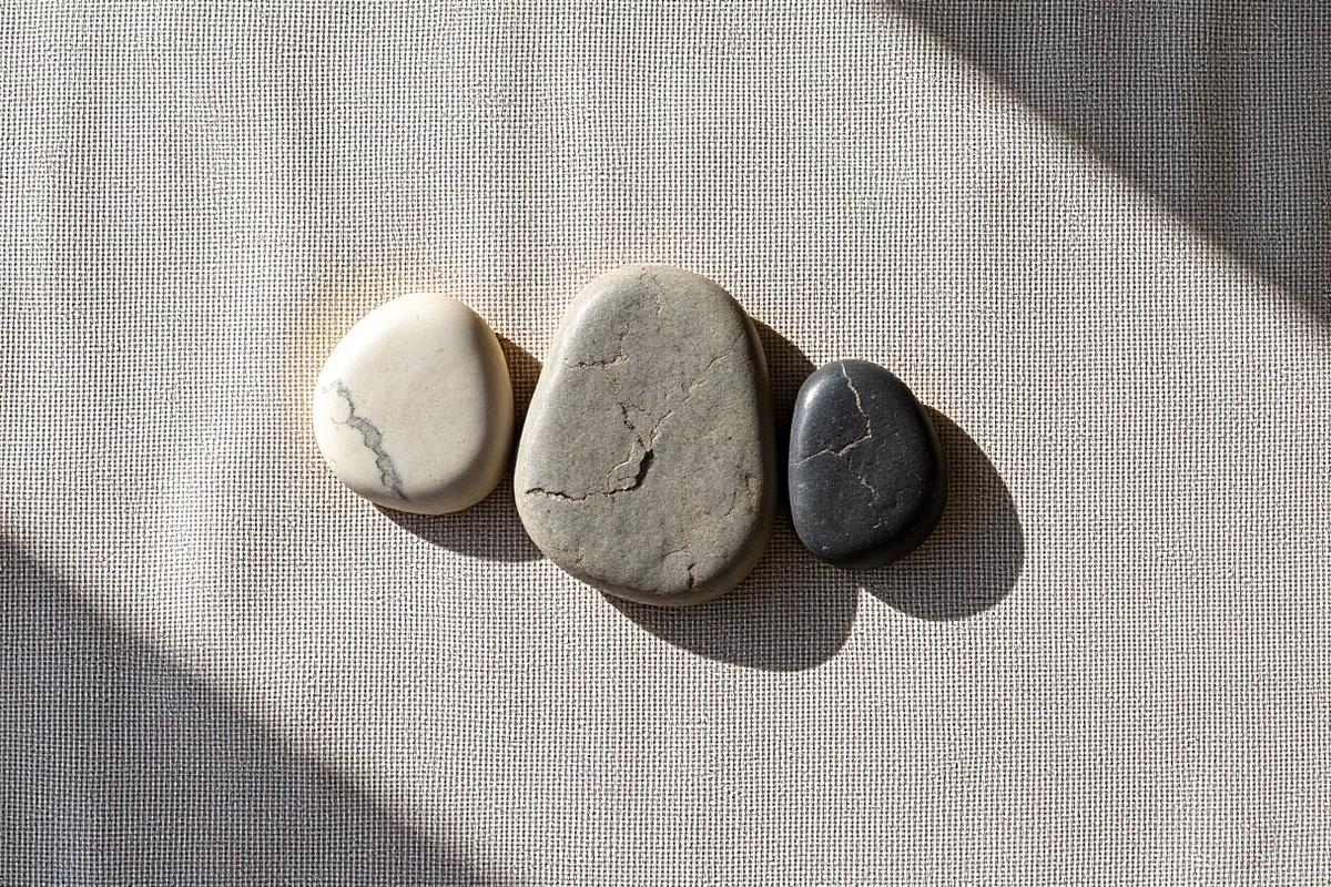 Three smooth river stones arranged in a precise triangle